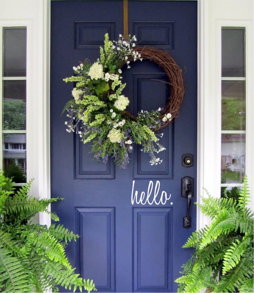 A Dark Blue Door Provides a Wonderful Contrast to a Green Planter