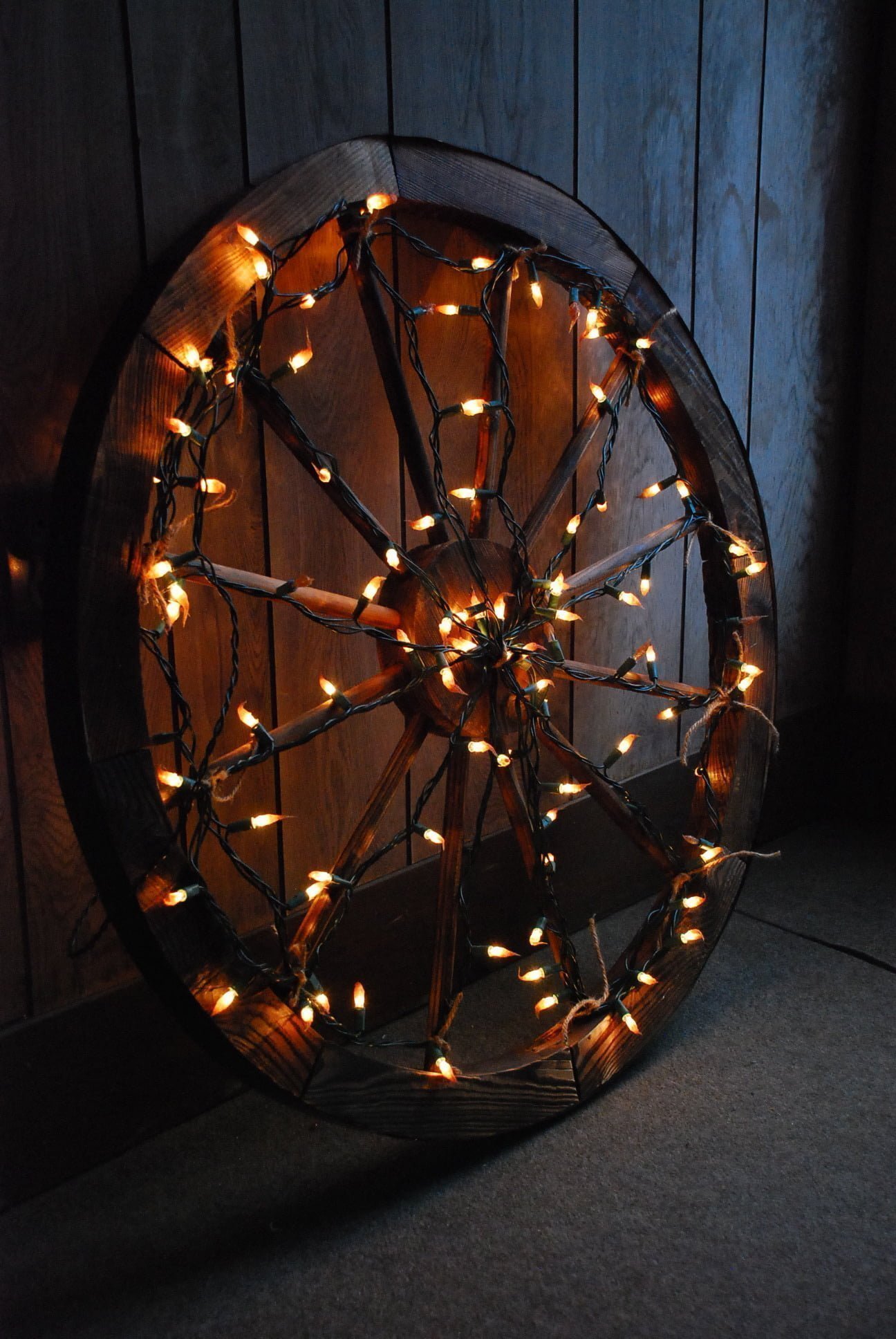 Wooden Spinning Wheel Wrapped in Lights