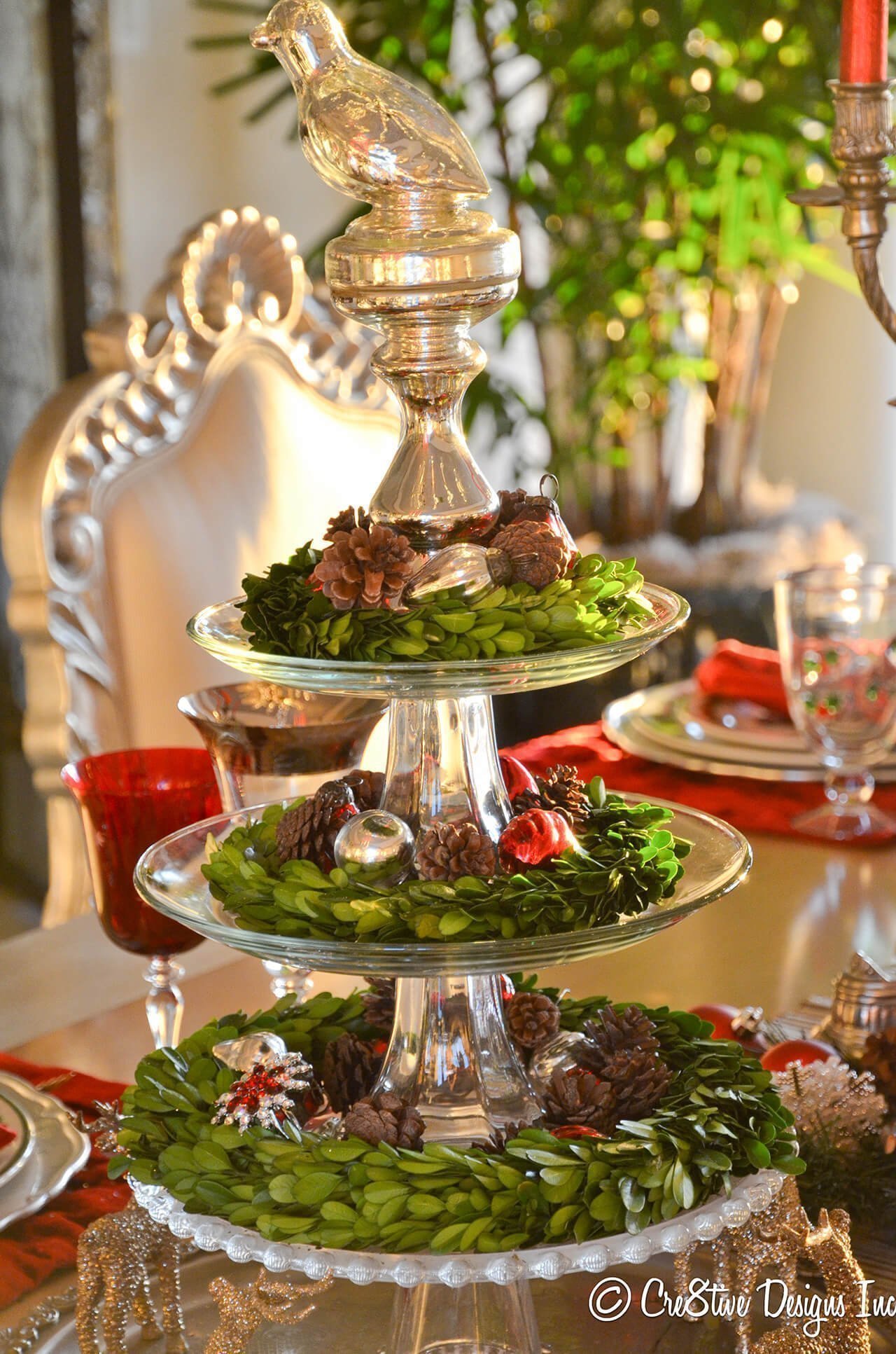 Tiered Display Of Boxwood Wreaths And Vintage Ornaments