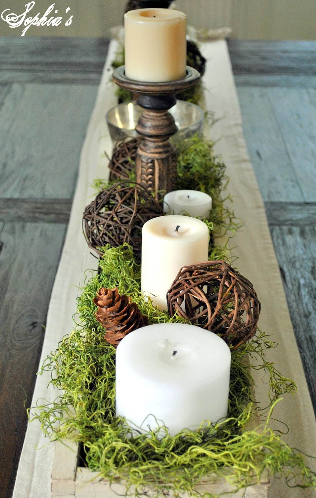 An Earthy Display with Fake Grass and Pine Cones