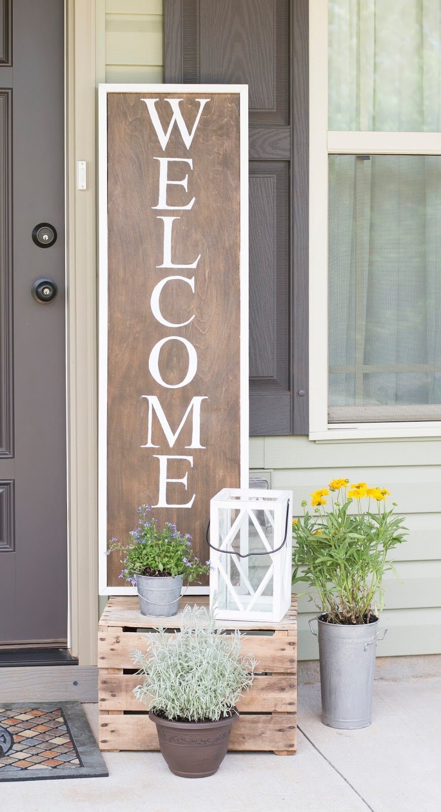 Wooden “Welcome” Sign and Metal Potted Plants