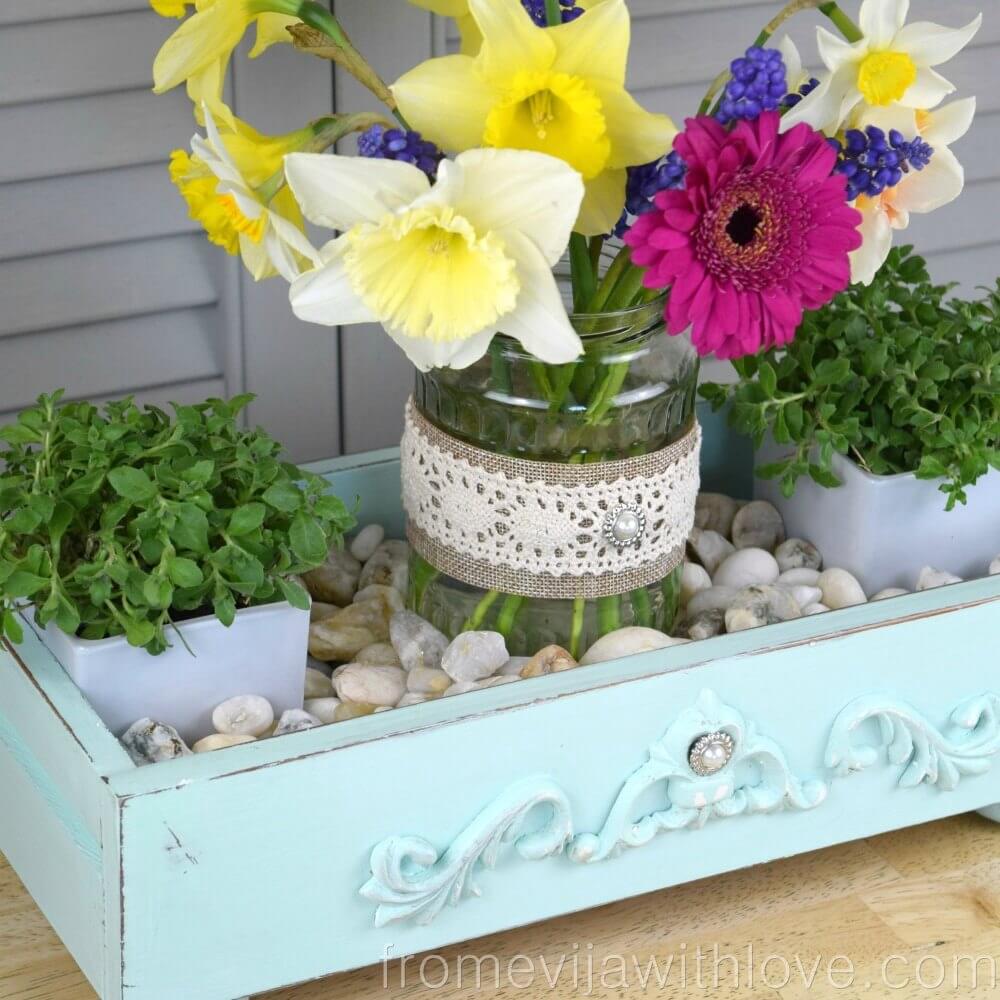 A Reclaimed Drawer with River Stones and Flowers