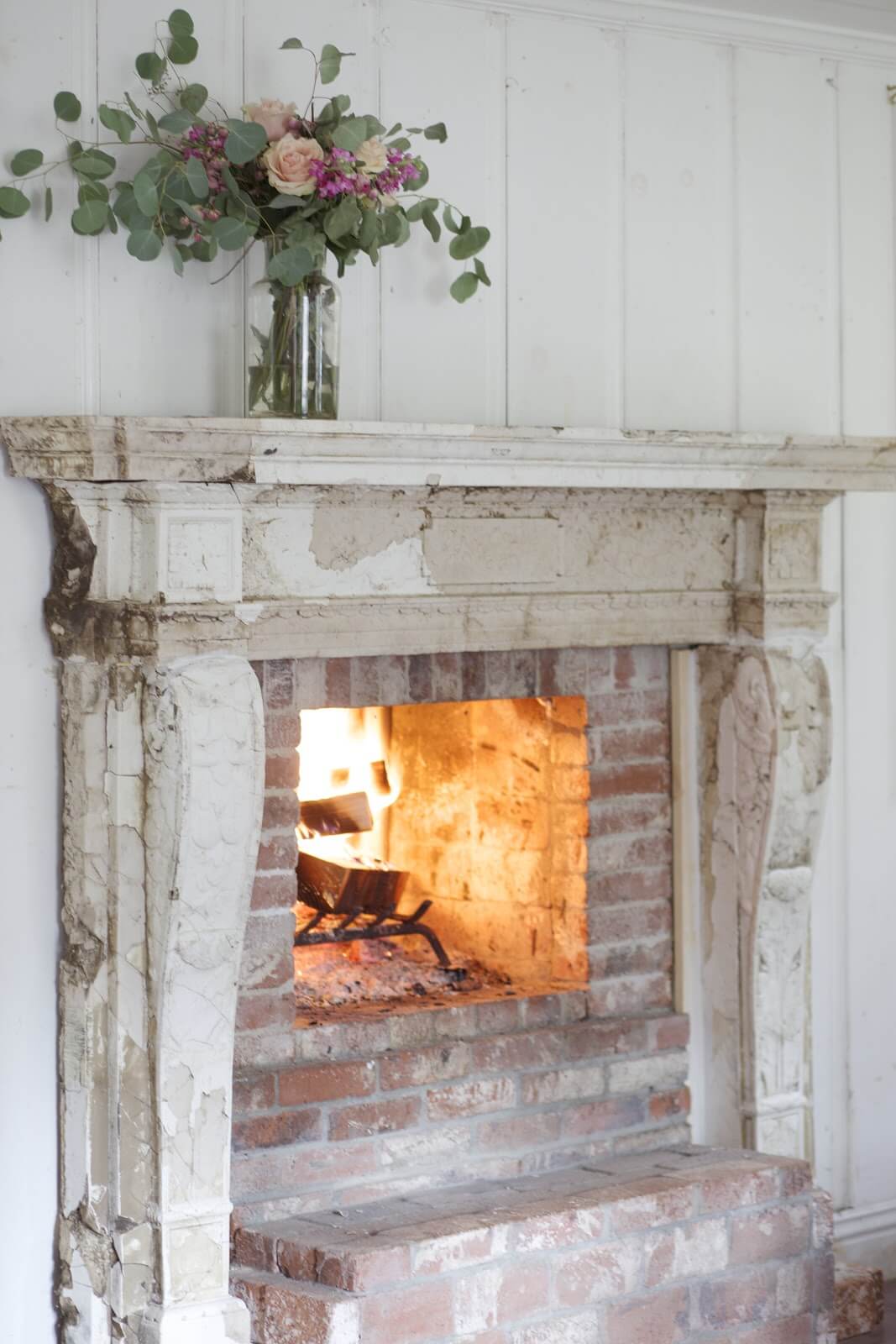 Distressed Wood Burning Fireplace with Flowers