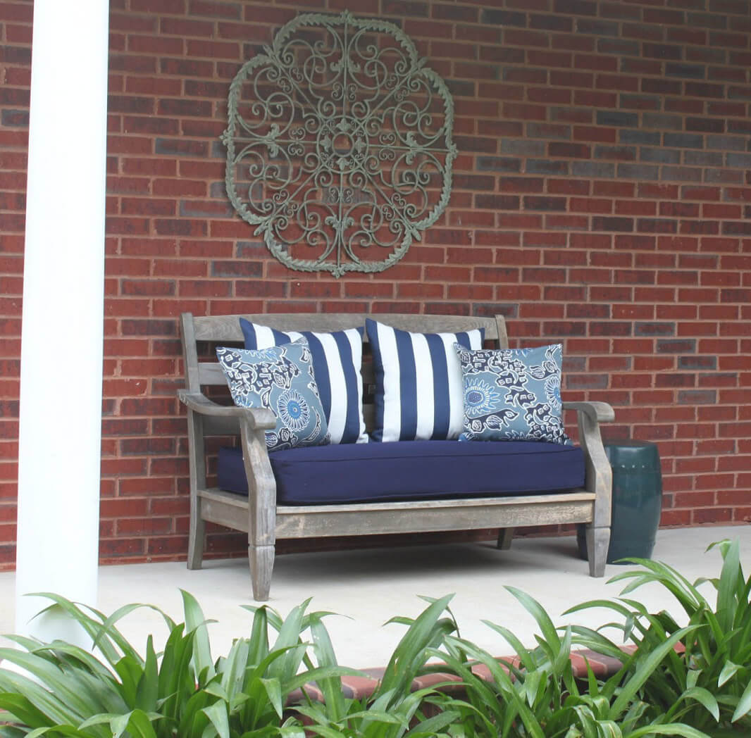 Metal Scrollwork Wall Hanging Over a Bench