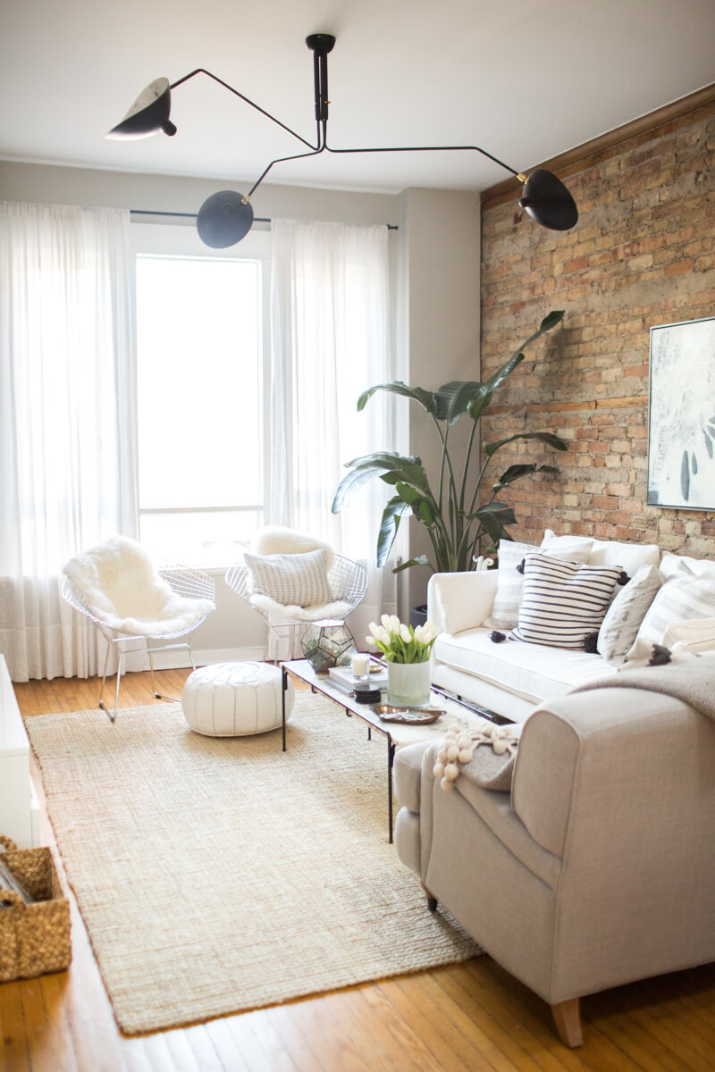 Exposed Brick, Creamy Couches, and Black Fixtures