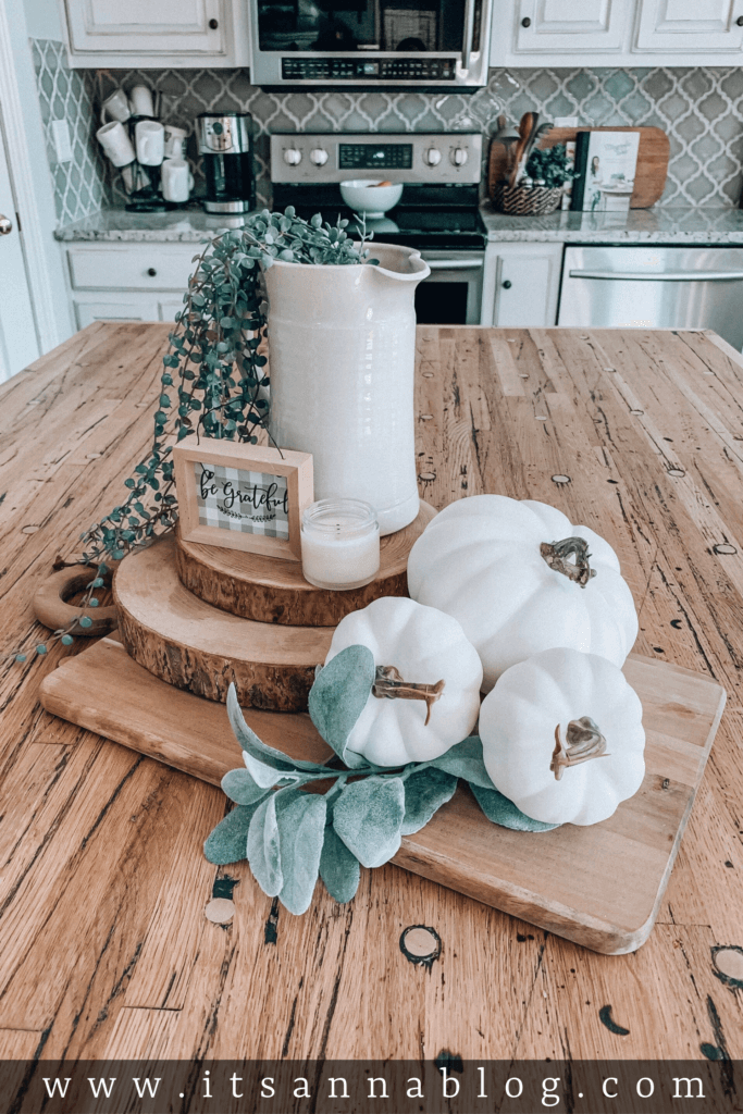 Wooden Circles and Pumpkin Vignette with Greenery