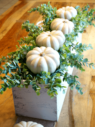 DIY Fall Centerpieces: Pumpkins Nestled on a Bed of Greens