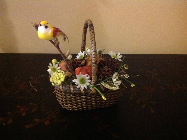 Basket Full of Earthy Plants and Bird on Branch