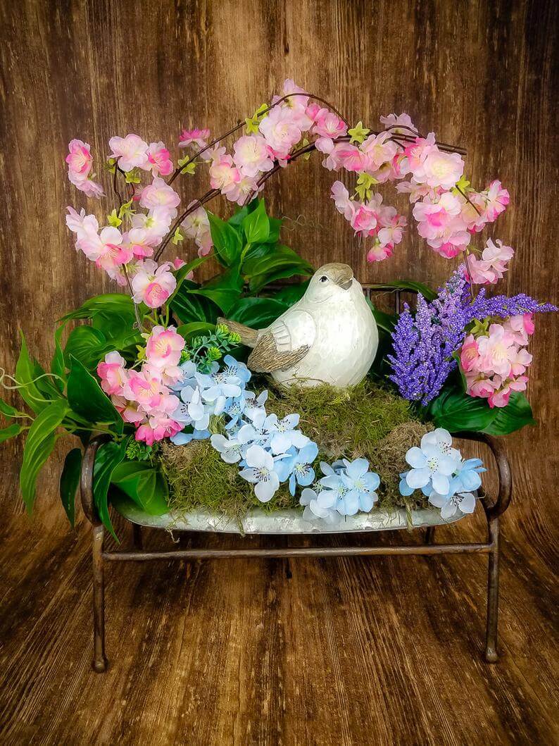 Small Rustic Bench with Nest and Green Plants